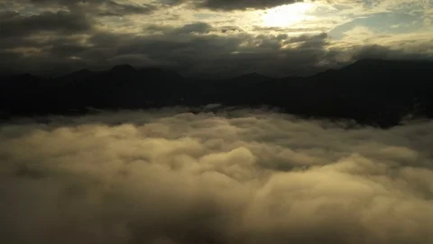 Aerial view flying in the clouds when the sunrise on the mountain Stock Footage 114753117