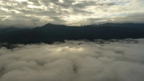 Aerial view flying in the clouds when the sunrise on the mountain 库存影片 116806712