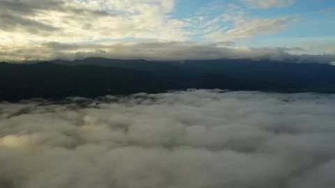 Aerial view flying in the clouds when the sunrise on the mountain Stock Footage 118759088