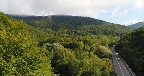 Aerial view from flying copter over beautiful sunny mountains covered with trees Stock Footage 85896404