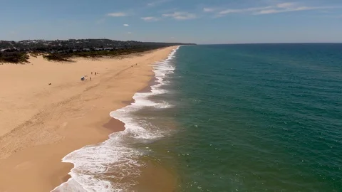 Aerial View Flying Down Beach with Waves Breaking Beach On Left Side Stock Footage 99020044