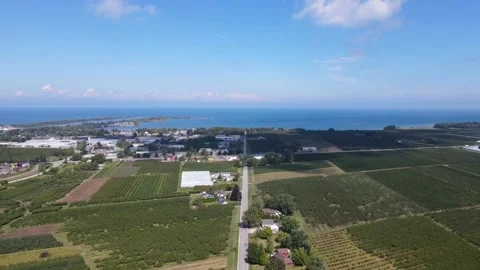 Aerial view flying down towards a rural road running through Niagara On Stock Footage 236447204