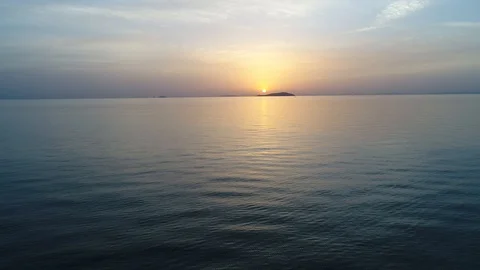Aerial view from flying drone of calm ocean at sunset Stock Footage 90333702