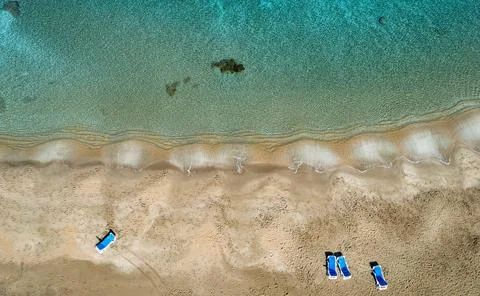 Aerial view from flying drone of empty sandy beach golden sand in winter. Photos