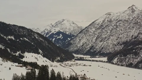 Aerial view flying forward over a valley in alps Stock Footage 125141529