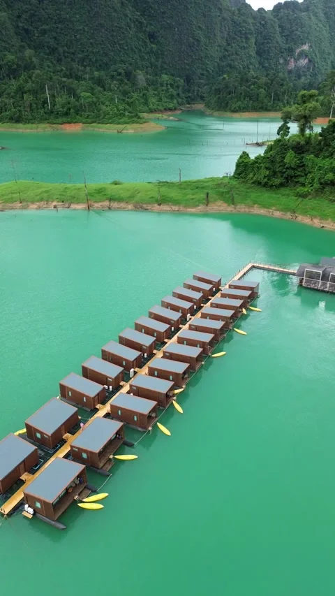Aerial view flying forward over floating bungalows on Cheow Lan Lake Stock Footage 336481712