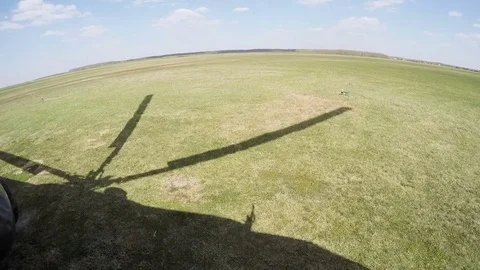 Aerial view from flying helicopter. Taking off. Camera inside. Stock Footage 79711351