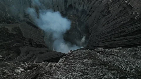 Aerial view flying to mount active volcano cloudy Bromo crater Stock Footage 277197573