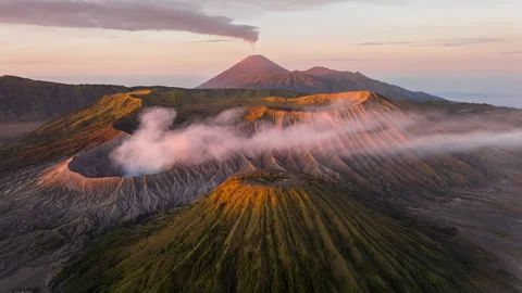 Aerial view flying to mount Bromo active volcano at sunrise, Java, Indonesia Stock Footage 244712385