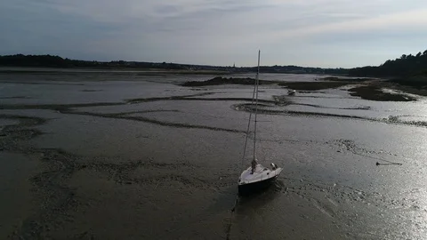 Aerial view. Flying over agrounded sailing boats at low tide in English channel  Stock Footage 120026121