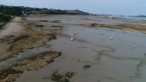 Aerial view. Flying over agrounded sailing boats at low tide in English channel 動画素材 120026488