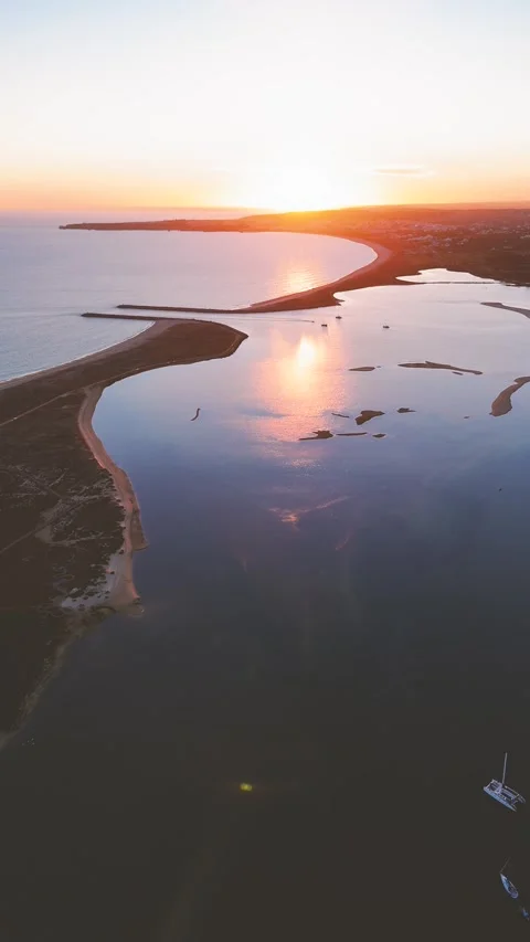Aerial view flying over Alvor estuary and harbor at sunset in Algarve Stock Footage 324499030
