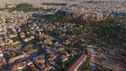 Aerial view flying over Athens towards the Acropolis and Parthenon Stock Footage 345413008