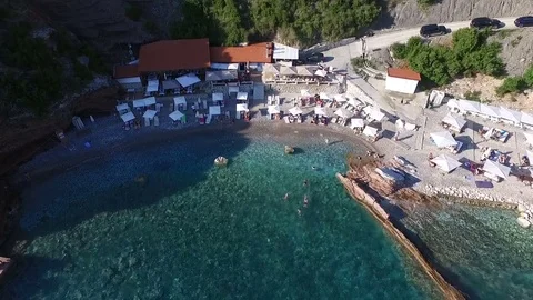 Aerial View: Flying over the beach with sun beds Stock Footage 76523581