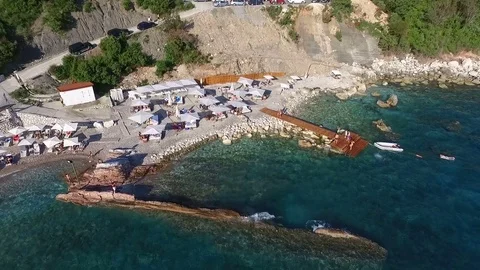 Aerial View: Flying over the beach with sun beds Stock Footage 76545571