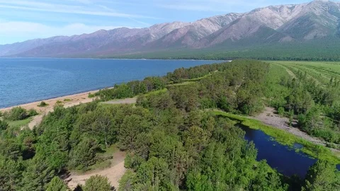 Aerial View. Flying over the beautiful lake near mountains. a. Stock Footage 77860853