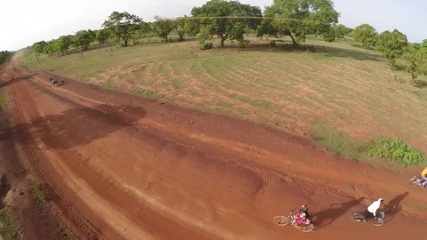 Aerial view - Flying over bicycles on unpaved road, Africa Stock Footage 83603802
