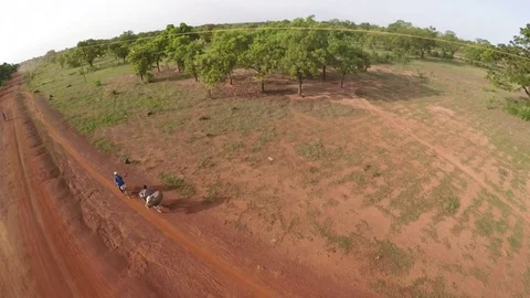 Aerial view - Flying over bicycles on unpaved road, Africa Stock Footage 83603833