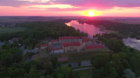 Aerial View. Flying over the castle's old town at sunset with sun rays. Stock Footage 63835634