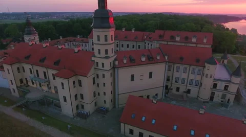 Aerial View. Flying over the castle's old town at sunset with sun rays. Stock Footage 63837848