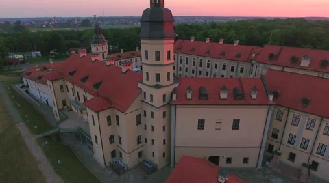 Aerial View. Flying over the castle's old town at sunset with sun rays. Stock Footage 63839015