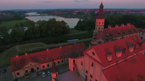 Aerial View. Flying over the castle's old town at sunset with sun rays. Stock Footage 63840604