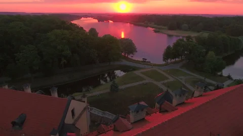 Aerial View. Flying over the castle's old town at sunset with sun rays. Stock Footage 63840947