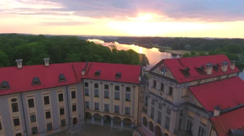 Aerial View. Flying over the castle's old town at sunset with sun rays. Stock Footage 64028392