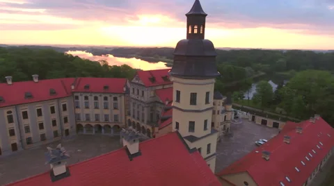 Aerial View. Flying over the castle's old town at sunset with sun rays. Stock Footage 64028730
