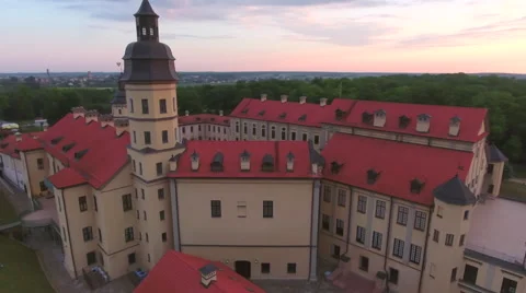 Aerial View. Flying over the castle's old town at sunset with sun rays. Stock Footage 64028780