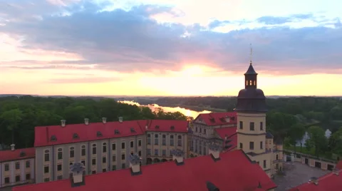 Aerial View. Flying over the castle's old town at sunset with sun rays. Stock Footage 64028872