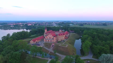 Aerial View. Flying over the castle's old town at sunset with sun rays. Stock Footage 64030024