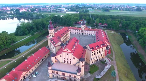 Aerial View. Flying over the castle's old town at sunset with sun rays. Stock Footage 64030388