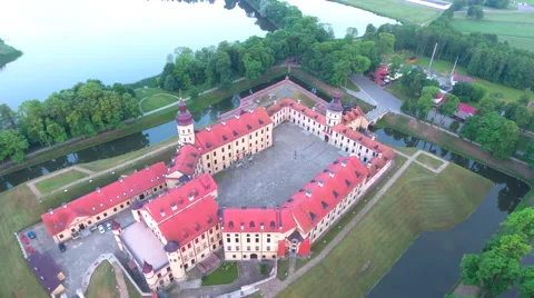 Aerial View. Flying over the castle's old town at sunset with sun rays. Stock Footage 64030501