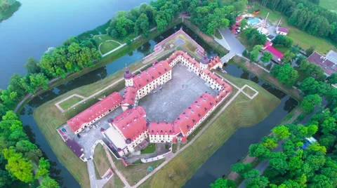 Aerial View. Flying over the castle's old town at sunset with sun rays. Stock Footage 64030507
