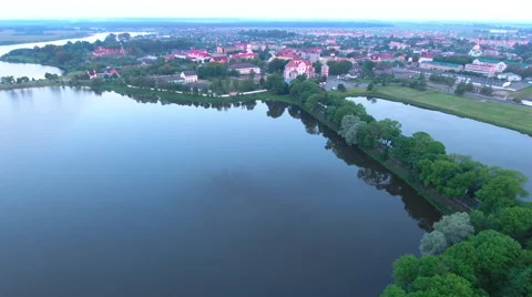 Aerial View. Flying over the castle's old town at sunset with sun rays. Stock Footage 64032565