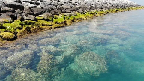 Aerial view flying over clear water bay Stock Footage 104403979