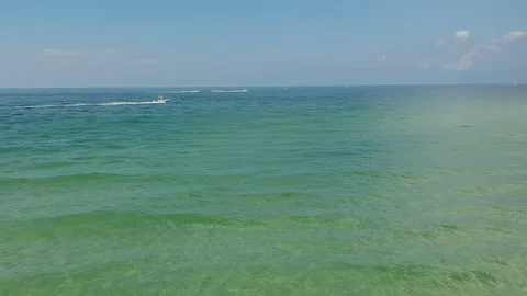 Aerial View Flying Over Clear Blue Sea with Boats Stock Footage 129384001