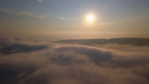 Aerial View of Flying Over Clouds at Sunrise Stock Footage 94729138