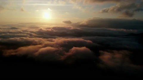 Aerial view: Flying Over Clouds on Sun Rise in Mountains. Stock Footage 162683842