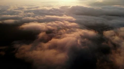 Aerial view: Flying Over Clouds on Sun Rise in Mountains. Stock Footage 162684044