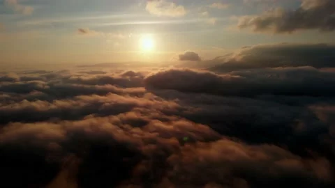 Aerial view: Flying Over Clouds on Sun Rise in Mountains. Stock Footage 162829812