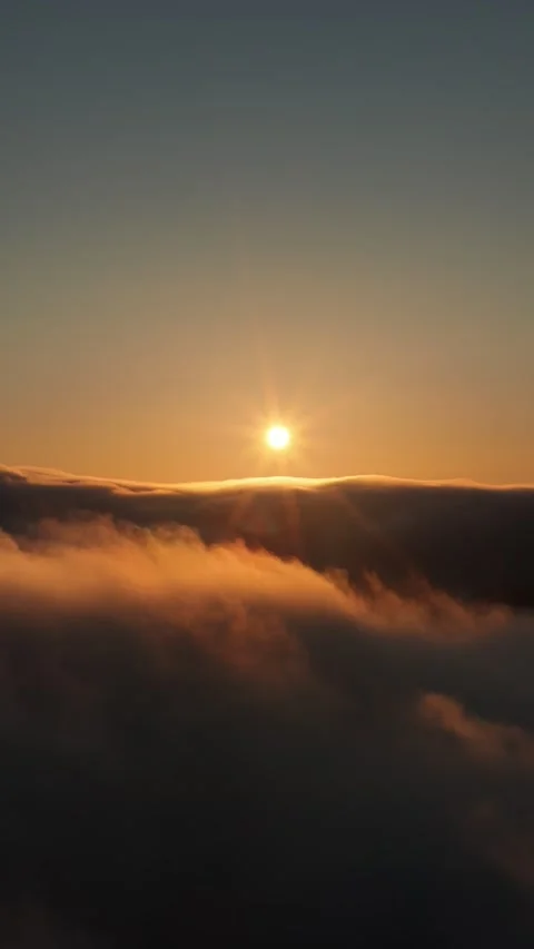 Aerial view flying over clouds during sunset Stock Footage 317917591