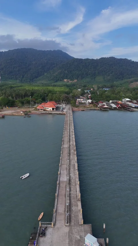 Aerial View Flying Over Concrete Pier Towards Tropical Island Village in Koh Stock Footage 335948329