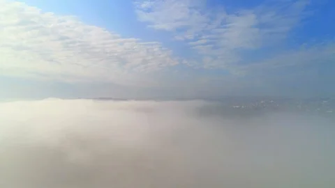 Aerial view flying over countyside area, so high the village is hidden by dense Video stock 111959527