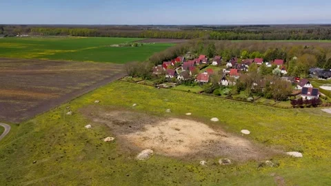 Aerial view flying over a dolmen archaeological site near a village Stock Footage 335064272