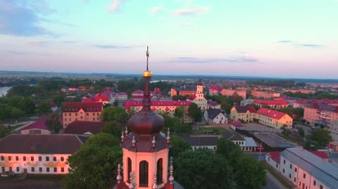 Aerial View. Flying over the dome of the church with a cross in the city at suns Stock Footage 63834696