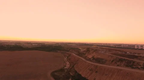 Aerial View. Flying over a dump in the middle of a field at sunset. Stock Footage 68000109