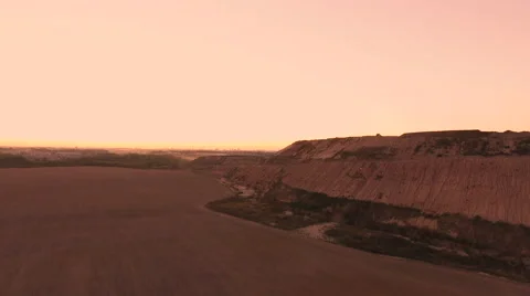 Aerial View. Flying over a dump in the middle of a field at sunset. Stock Footage 68000222