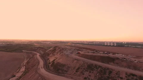 Aerial View. Flying over a dump in the middle of a field at sunset. 스톡 동영상 68001534
